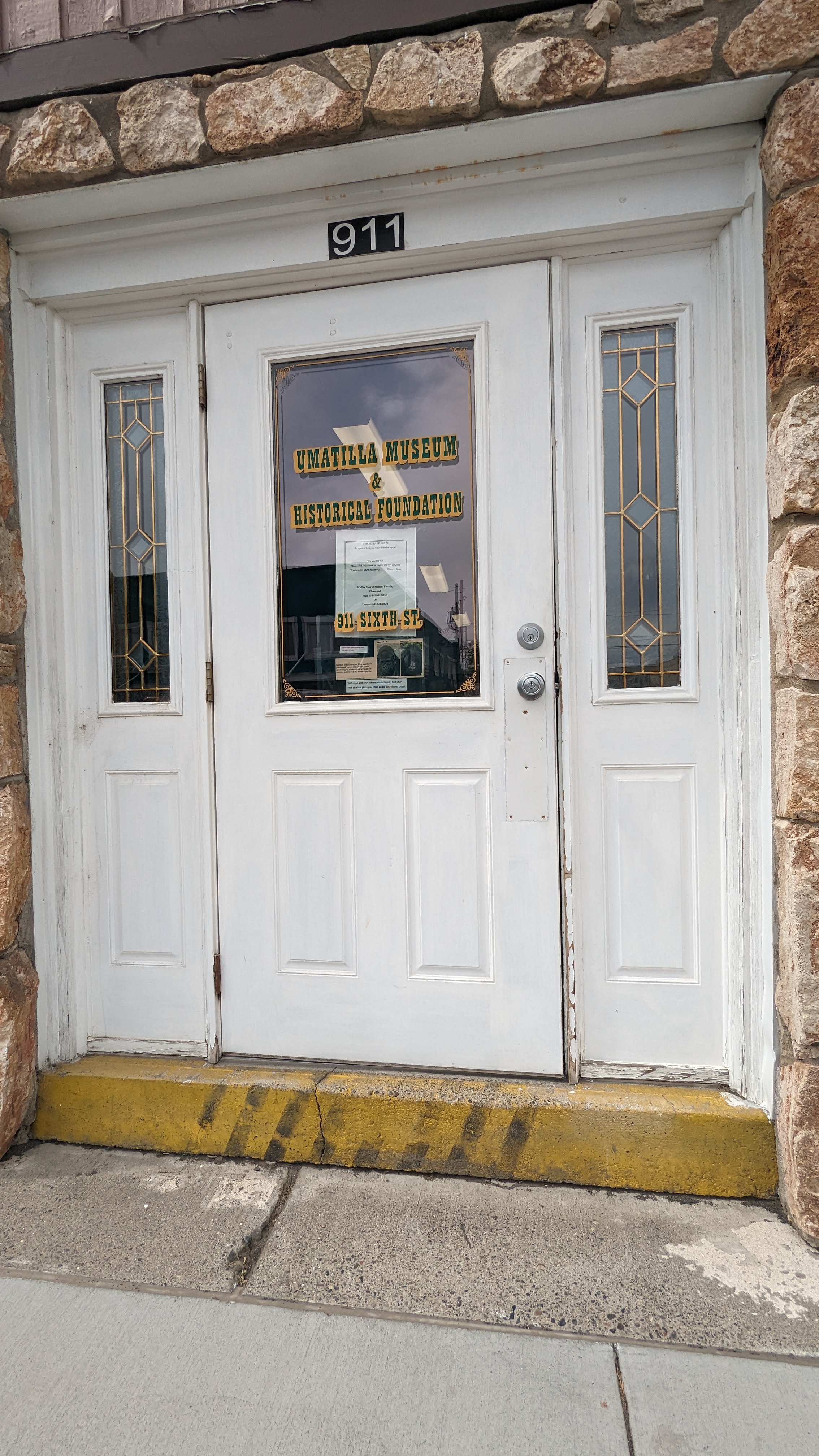 Front door with large step, door opens to view of front desk to ask for assistance to ramp entrance.